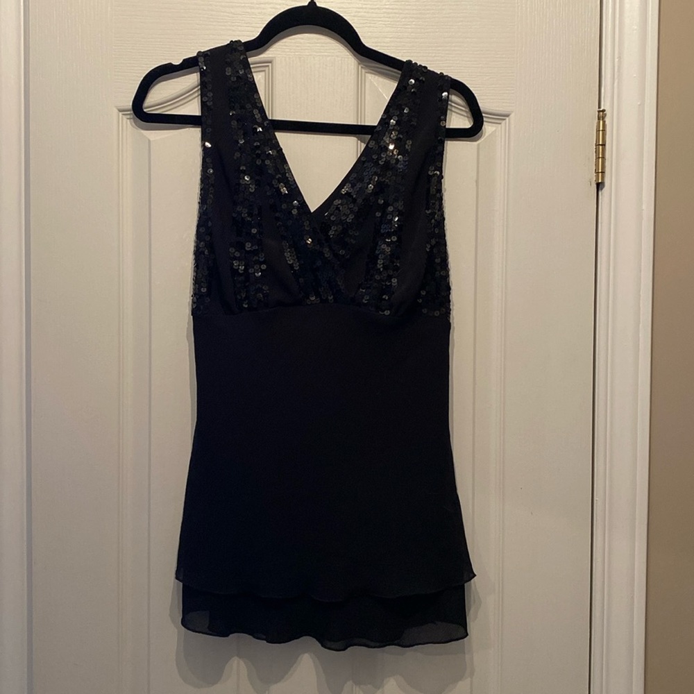 Sleeveless top with sequinned bust.